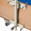 Upper and lower clamps attach to metal head board of hospital bed