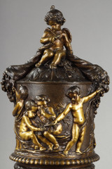 Pair of covered vases, in finely chased bronze with a rich rotating decoration