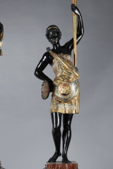 Pair of black and polychrome lacquered wood torchholders depicting Nubians