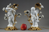 Pair of candelabra in biscuit and gilt bronze