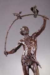Bronze statue of a bird charmer