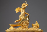 Empire period clock with a putto in a chariot