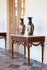 PAIR OF LOUIS XVI STYLE CONSOLE TABLES IN WALNUT AND MARBLE