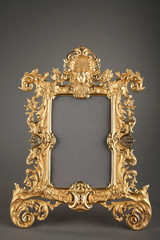 REGENCY-STYLE GILDED BRONZE FRAME DECORATED WITH MASCARON AND LEAVES
