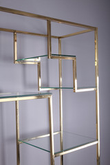 BRASS AND GLASS BOOKCASE BY KIM MOLTZER (1938-2015)