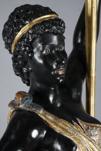 Pair of black and polychrome lacquered wood torchholders depicting Nubians
