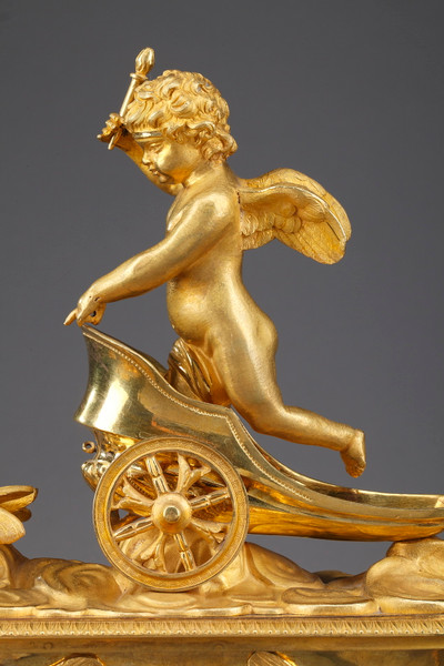 Empire period clock with a putto in a chariot