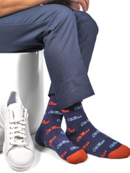 Sitting in navy dress socks with Ole Miss script on red and powder blue Sitting in navy dress socks with Ole Miss script on red and powder blue