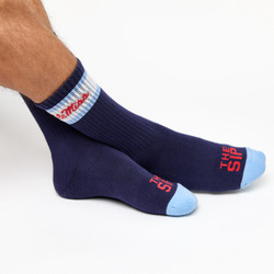 Navy casual crew socks with Ole Miss script on the side of the calf shown on feet crossed. Navy casual crew socks with Ole Miss script on the side of the calf shown on feet crossed.