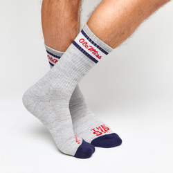 Grey casual crew socks with Ole Miss script on the leg and two retro stripes shown on legs. Grey casual crew socks with Ole Miss script on the leg and two retro stripes shown on legs.