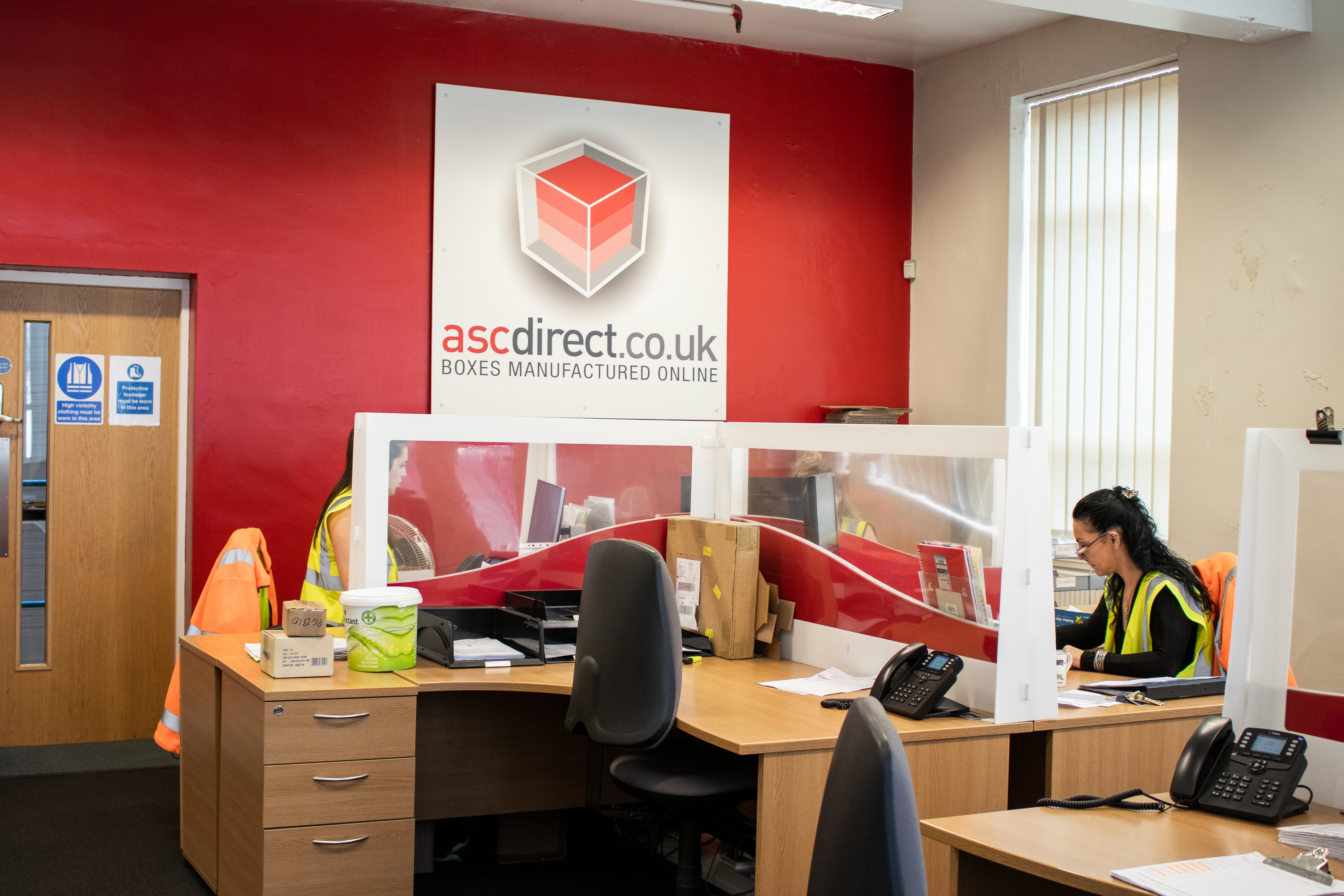 ASC Direct admin office with female staff members wearing high visibility vests