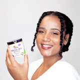 Woman with defined natural curls styled using Alikay Naturals Moisture Rich Hair Parfait custard