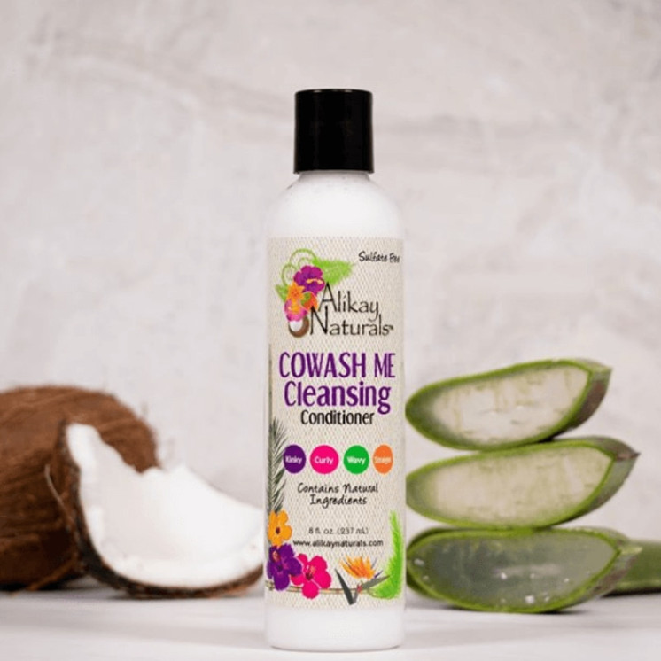 Woman co-washing natural curly hair with Alikay Naturals CoWash Me Cleansing Conditioner for moisture and frizz control