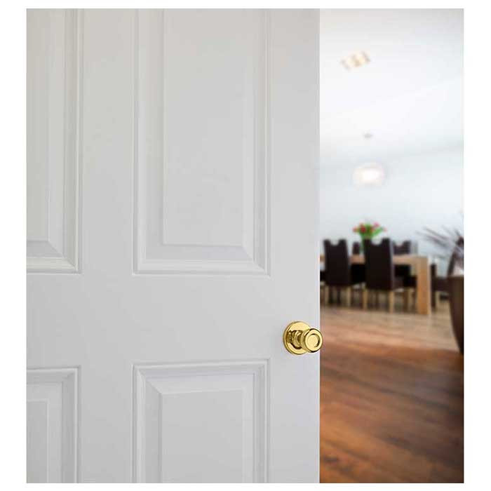 Kwikset Tylo Passage Knob With 6-Way Adjustable Latch And Round Corner Strike, Bright Polished Brass