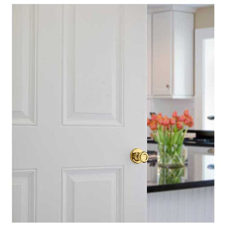 Kwikset Tylo Passage Knob With 6-Way Adjustable Latch And Round Corner Strike, Bright Polished Brass