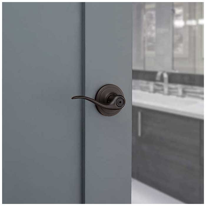 Kwikset Tustin Privacy Lever With 6-Way Adjustable Latch And Round Corner Strike, Venetian Bronze