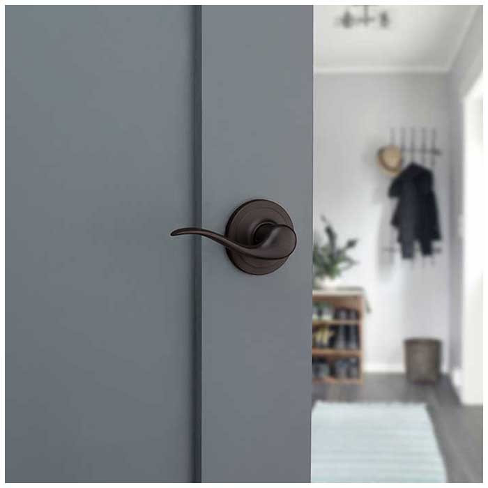 Kwikset Tustin Passage Lever With 6-Way Adjustable Latch And Round Corner Strike, Venetian Bronze