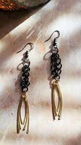 Lightweight dangle earrings featuring black metal links and gold teardrop tassels — unique two-tone fashion earrings