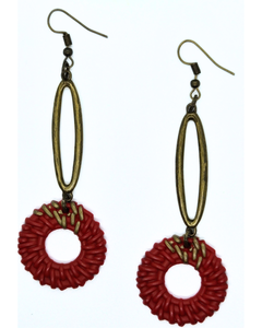 Boho-style orange rattan earrings with elongated antique-tone oval design