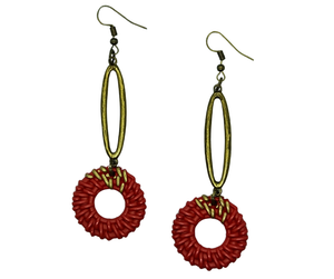 Boho-style orange rattan earrings with elongated antique-tone oval design