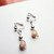 Handcrafted tan and white agate clip-on earrings with floating stone design
