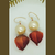 Nature-inspired bud and pearl earrings in orange and white tones