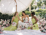 A bride and her bridesmaid holding bouquets from the Charlotte Collection