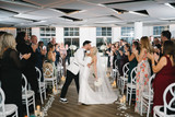 Bride and Groom kissing while walking out of their ceremony
