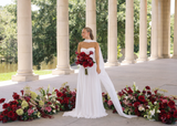  Bride in a modern white gown holding a red rose and calla lily bridal bouquet surrounded by red and green florals