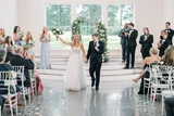 Bride and groom celebrate after saying "I do" in front of their guests.