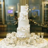 Wedding cake decorated with white orchids from the Wren Collection
