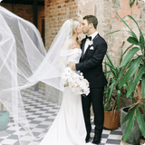Bride and Groom kissing with bride holding the Wren Bridal Bouquet