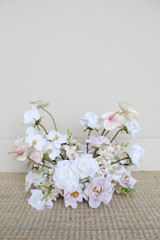 Garden-style floral arrangement featuring blush anthuriums, white phalaenopsis orchids, blush roses, and ivory blooms.