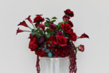 Stella Rouge Floral Meadow featuring rich red roses, deep burgundy peonies, burgundy calla lilies, garden roses, cascading burgundy amaranthus, and lush greenery. This premium silk floral arrangement creates a bold, dramatic statement for wedding aisles, sweetheart tables, ceremony backdrops, and reception décor.