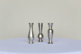 Three silver bud vases in different shapes on a white table in front of a white background.