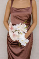 Bridesmaid bouquet featuring blush anthuriums, white phalaenopsis orchids, and delicate blush orchid blooms.