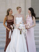 Bridesmaids standing with the bride while carrying Blush Anthurium Petite Bouquets composed of three blush pink anthuriums and elegant ribbon accents.