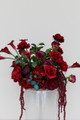 Stella Rouge Floral Meadow featuring rich red roses, deep burgundy peonies, burgundy calla lilies, garden roses, cascading burgundy amaranthus, and lush greenery. This premium silk floral arrangement creates a bold, dramatic statement for wedding aisles, sweetheart tables, ceremony backdrops, and reception décor.