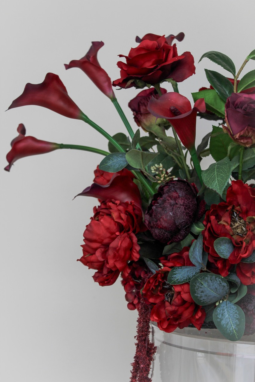 Stella Rouge Floral Meadow featuring rich red roses, deep burgundy peonies, burgundy calla lilies, garden roses, cascading burgundy amaranthus, and lush greenery. This premium silk floral arrangement creates a bold, dramatic statement for wedding aisles, sweetheart tables, ceremony backdrops, and reception décor.