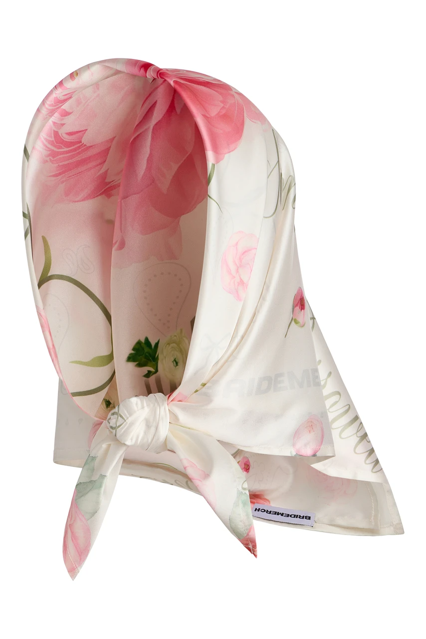 Ivory satin floral scarf featuring soft pink peony and ranunculus print, styled as a headscarf with a knotted front