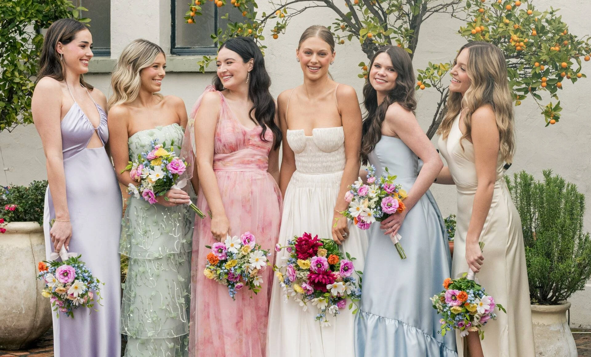 Bridal group posing with SBB flowers