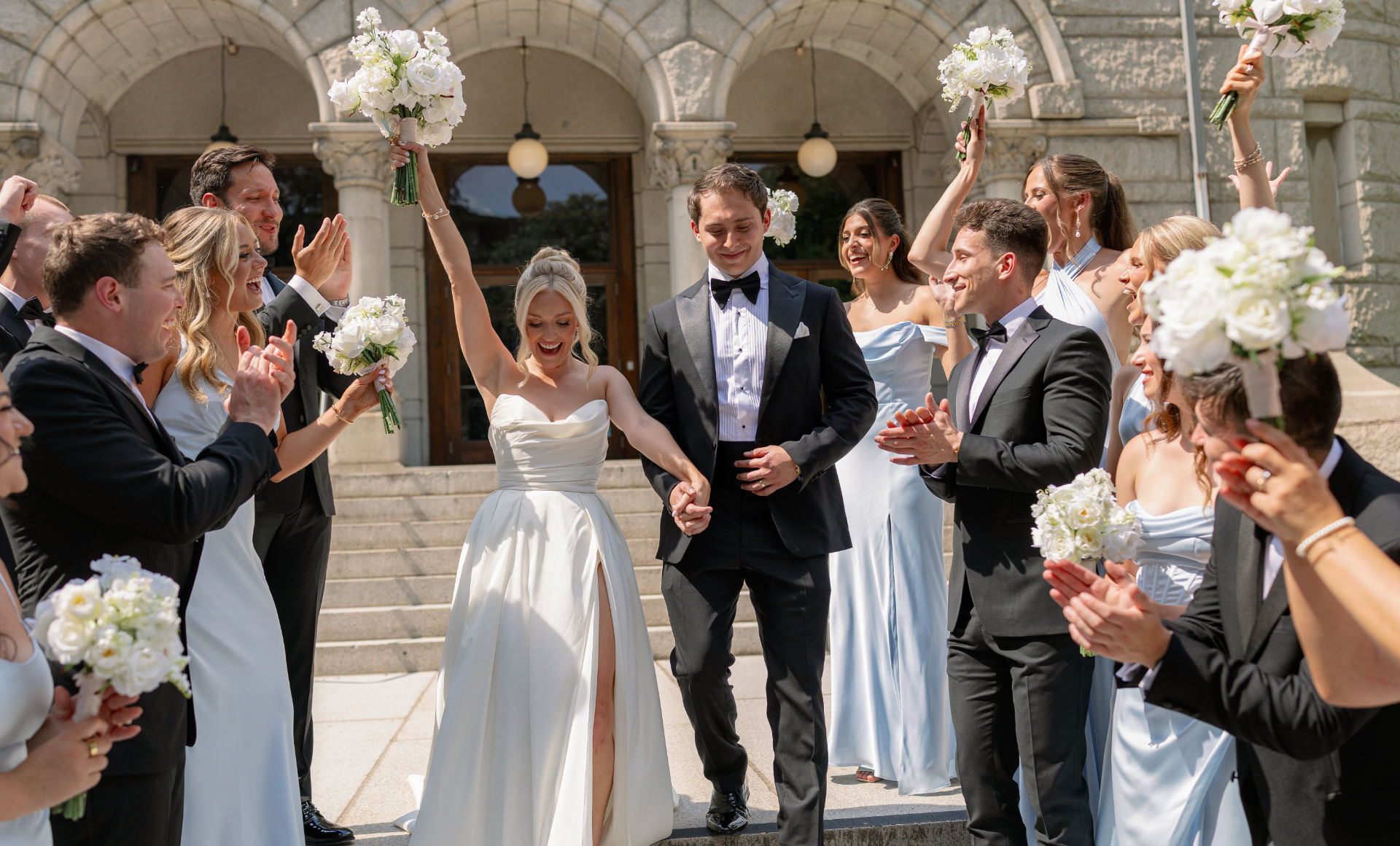 Newly married couple celebrating with silk flower bouquets from Something Borrowed Blooms