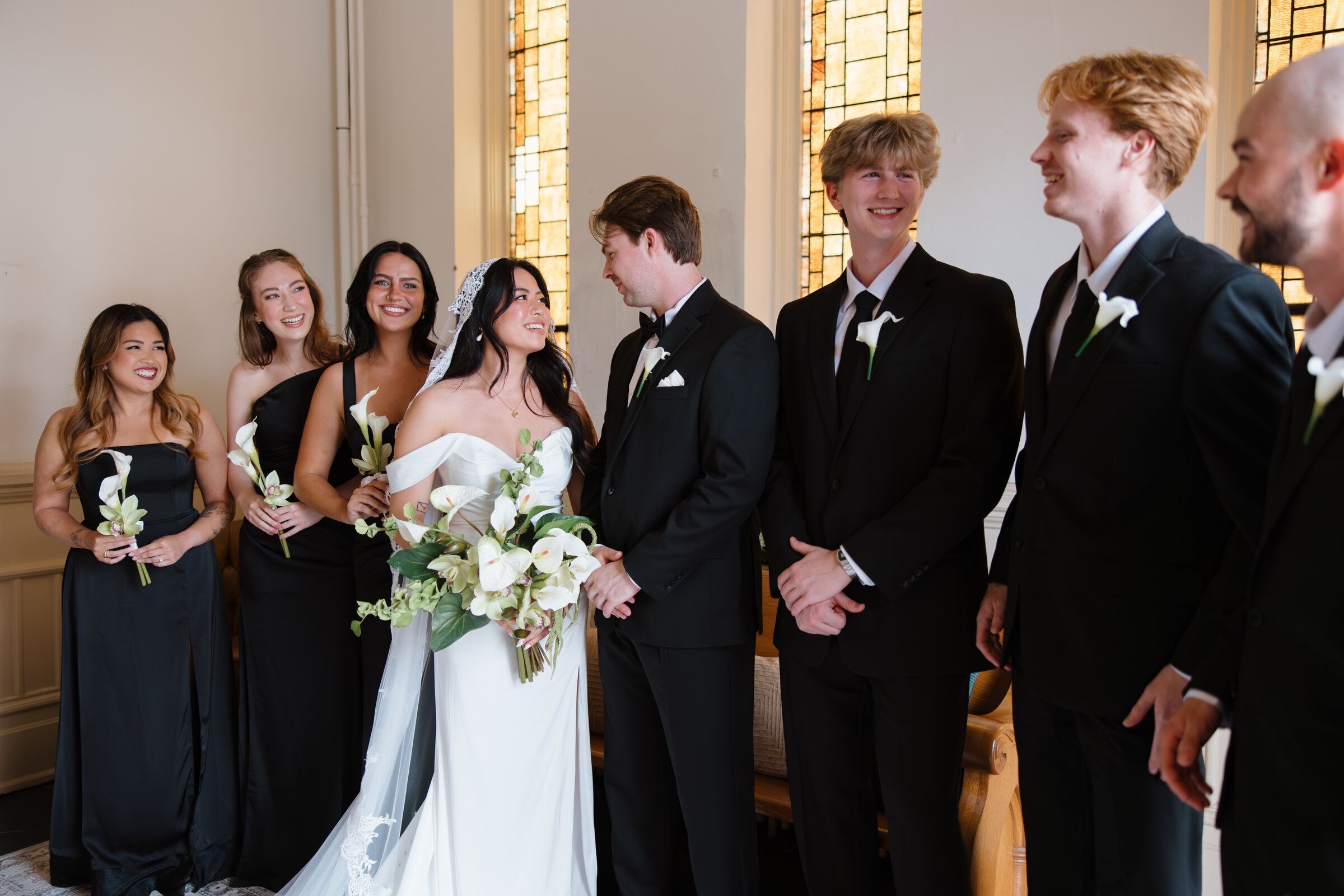 Bride holding beautiful SBB flowers as she kisses groom