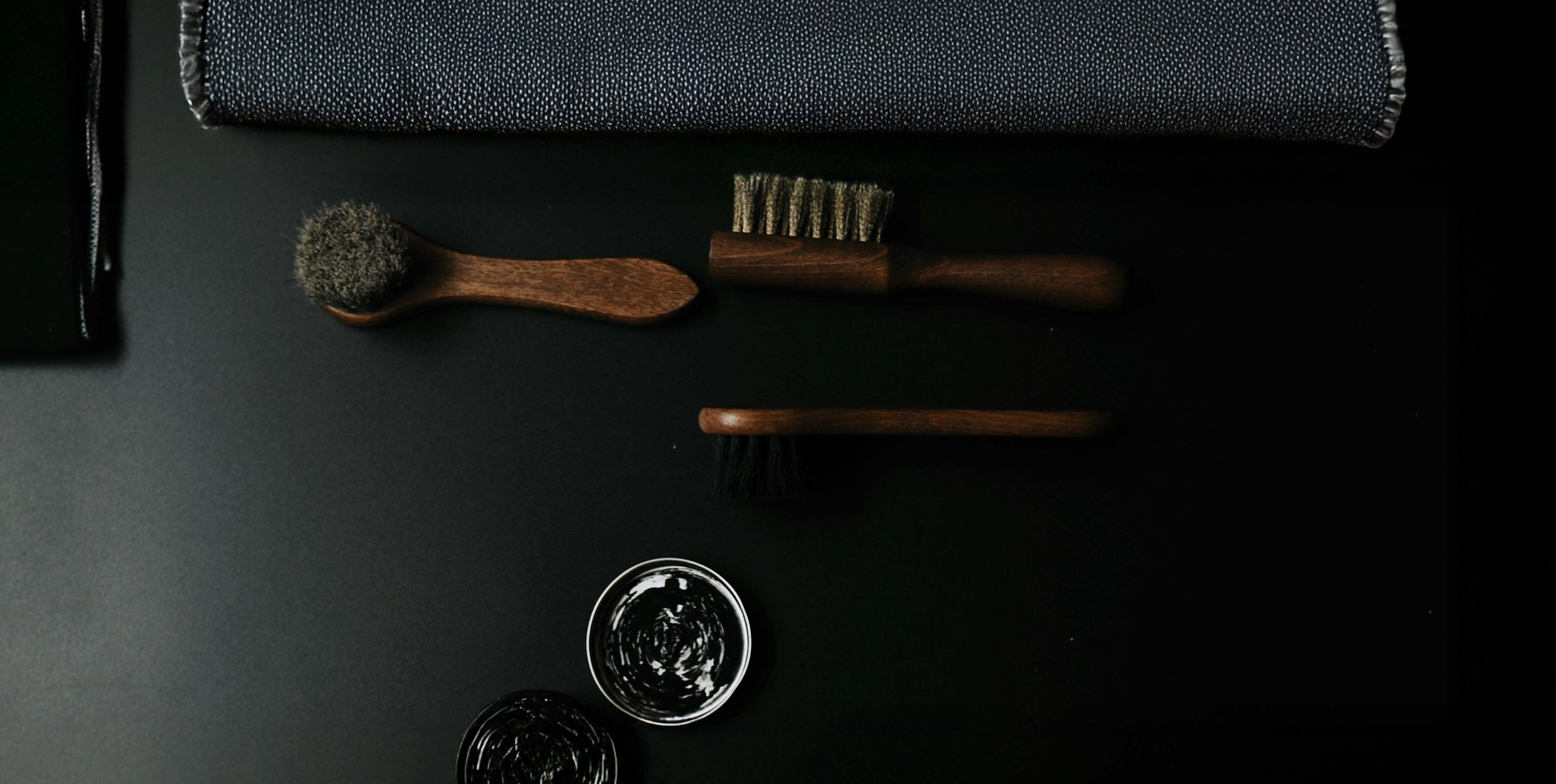 leather care items including a brush, rag and polishes