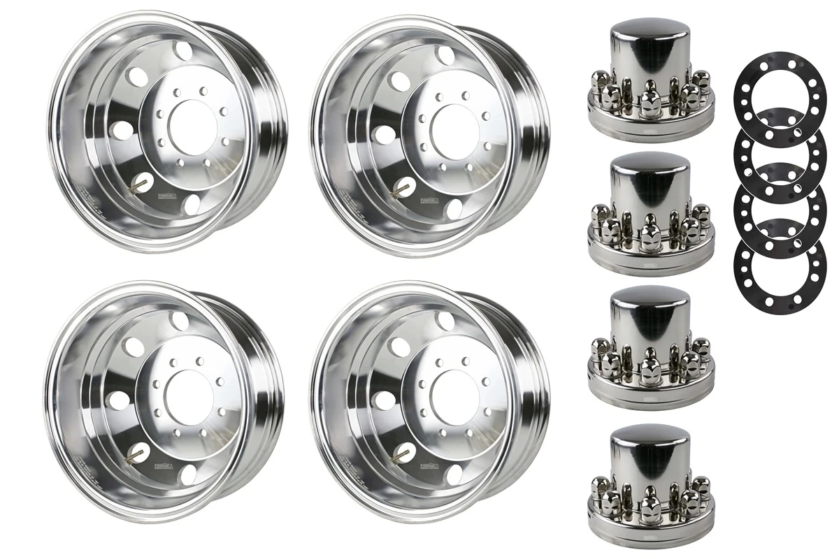 Four polished aluminum trailer wheels with center caps, lug nuts and spacers