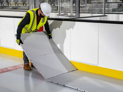 Laying down EverBase3 tiles to cover an ice rink.