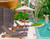 Poolside folding wicker partition in use to block out the neighbors from wanting to join.