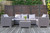 An outdoor patio setting featuring the folding wicker partition in the back.