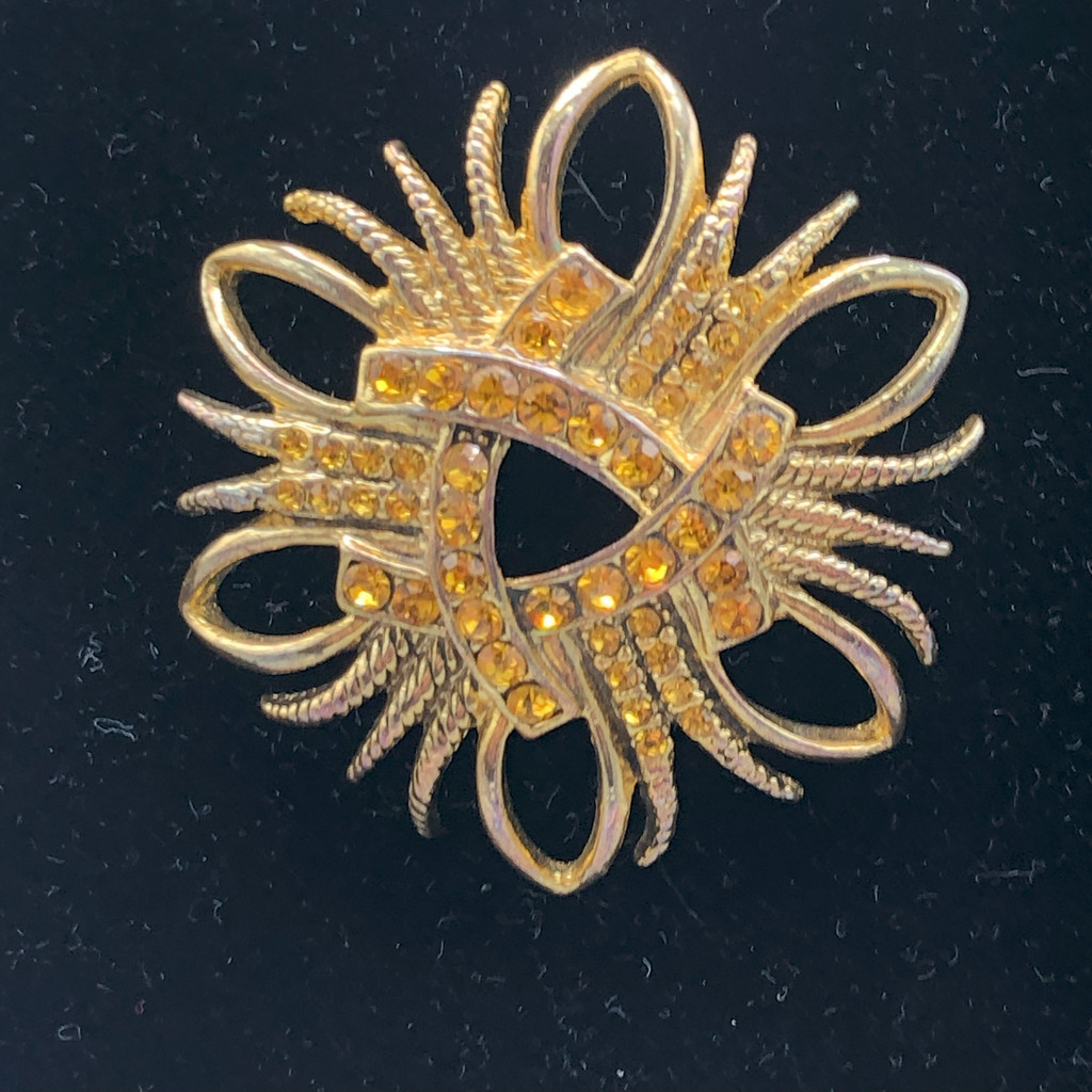 Gold tone crystal brooch