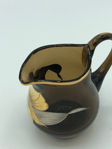 Brown glass creamer with gold & silver flowers